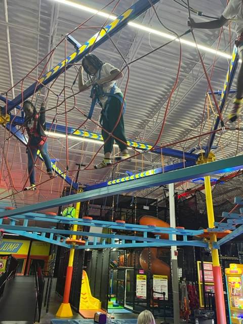 Students navigating a high ropes course